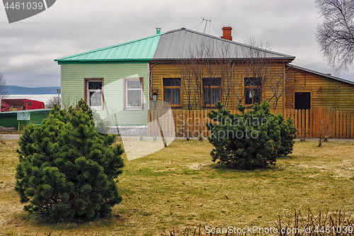 Image of Old and new wooden house of two different colored halves