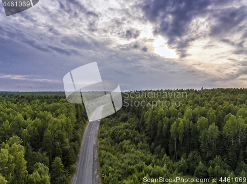 Image of Aerial view of old asphalt road through wild forest