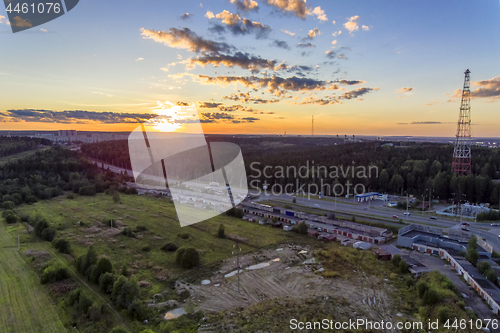 Image of Aerial view of city highway at sunset