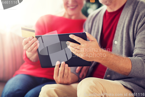 Image of senior couple with tablet pc shopping online