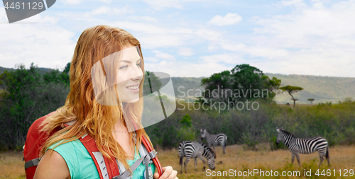 Image of happy woman with backpack over african savannah