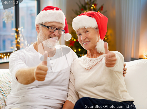 Image of happy senior couple at home on christmas