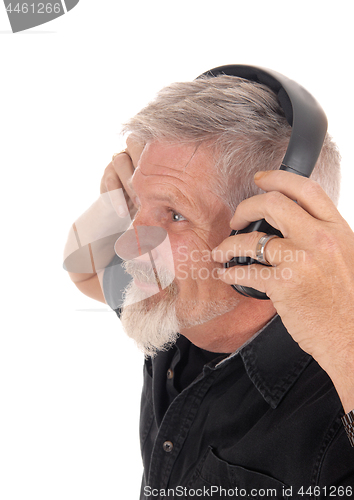 Image of Middle age man listening to music