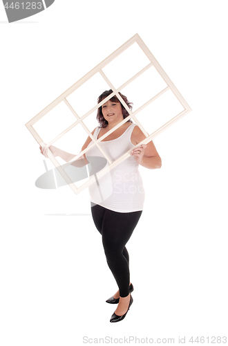Image of Big woman holding window frame