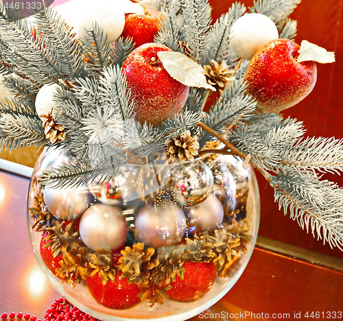 Image of Christmas holidays composition with red apples, silver balls, andglass vase