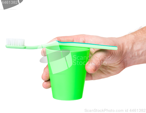 Image of Hand with toothbrush on white 