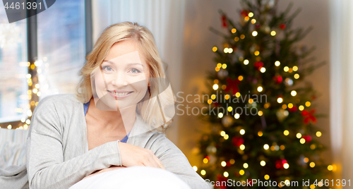 Image of happy middle aged woman at home on christmas