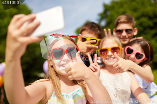 Image of kids taking selfie and showing thumbs up at park