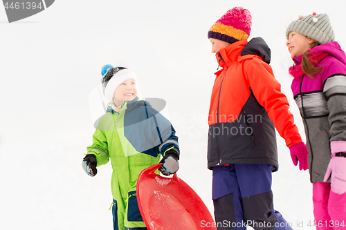 Image of happy little kids with sleds in winter