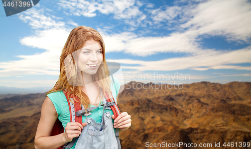 Image of smiling woman with backpack over grand canyon