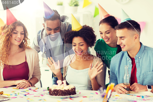 Image of team greeting colleague at office birthday party