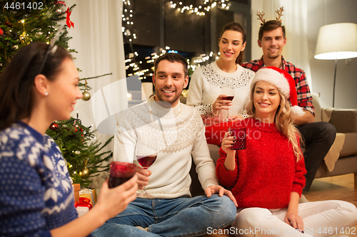 Image of friends celebrating christmas and drinking wine