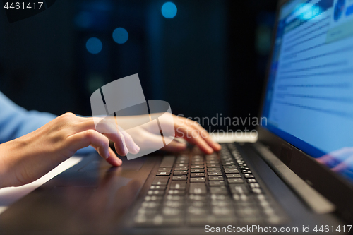 Image of close up of female hands with laptop typing