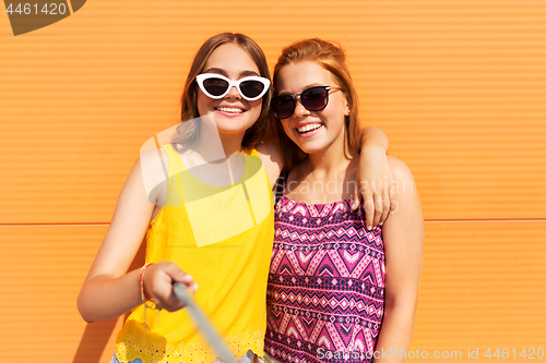 Image of teenage girls taking selfie outdoors in summer