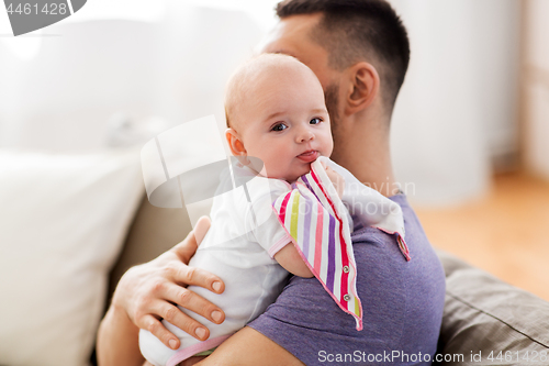 Image of father with little baby girl at home