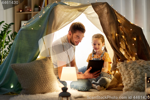 Image of family with tablet pc in kids tent at home