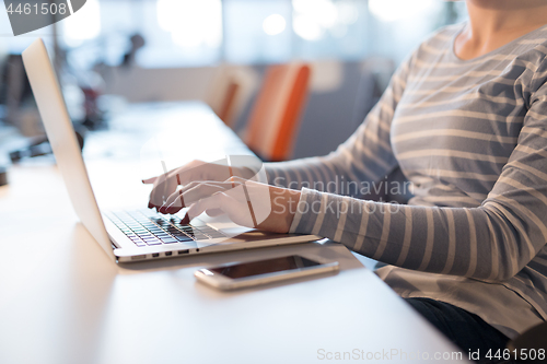 Image of businesswoman using a laptop in startup office