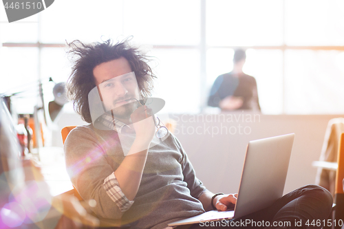 Image of Young businessman using computer at work