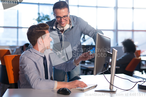 Image of Two Business People Working With computer in office