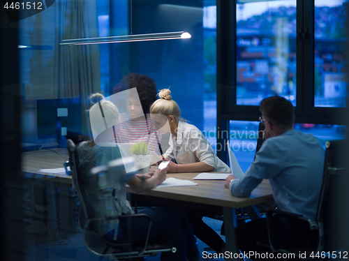 Image of Multiethnic startup business team in night office