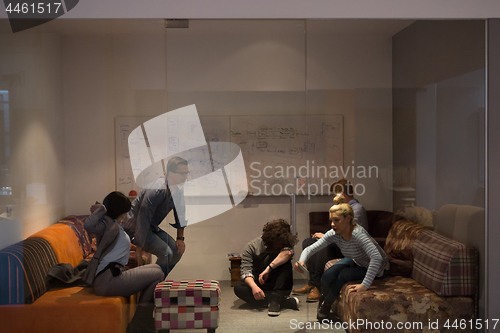 Image of software developers sleeping on sofa in creative startup office