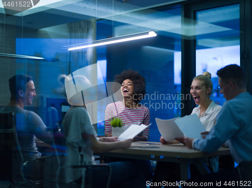 Image of Multiethnic startup business team in night office