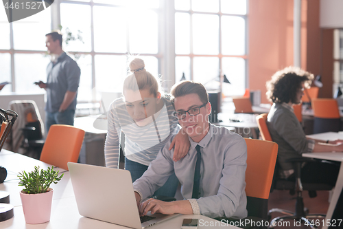 Image of Two Business People Working With laptop in office