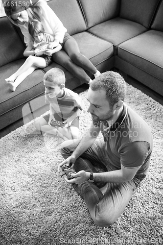 Image of Happy family playing a video game