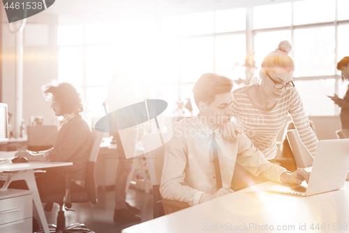 Image of Young businesswoman helping his colleague at the work