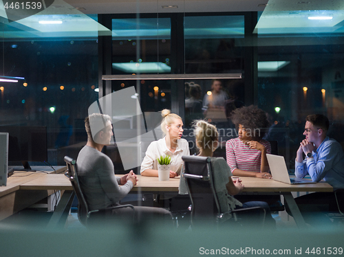 Image of Multiethnic startup business team in night office
