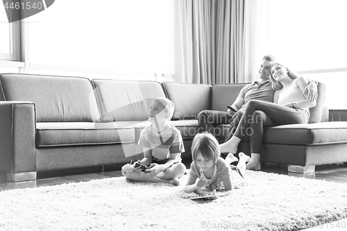 Image of couple spending time with kids