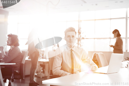 Image of Young businessman using computer at work