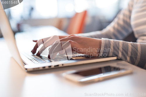 Image of businesswoman using a laptop in startup office