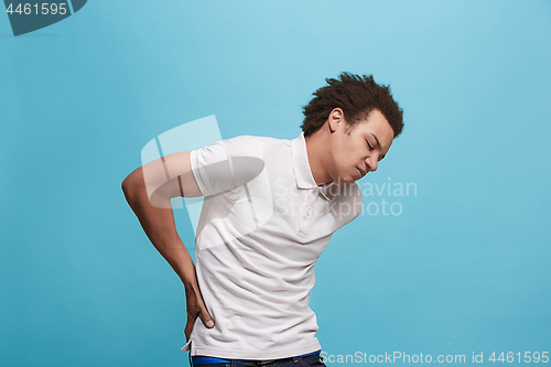 Image of Young man overwhelmed with a pain in the back