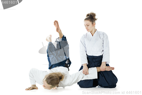 Image of Man and woman fighting at Aikido training in martial arts school