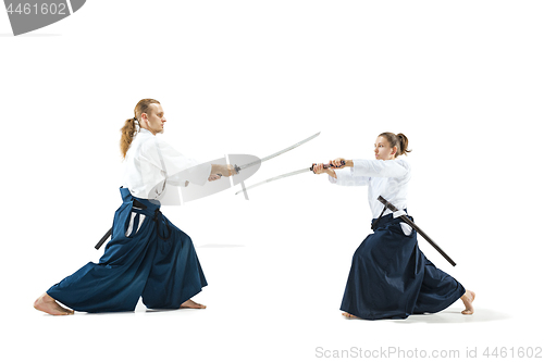 Image of Man and woman fighting and training aikido on white studio background