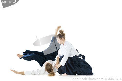 Image of Man and woman fighting at Aikido training in martial arts school