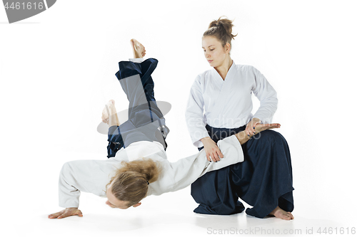 Image of Man and woman fighting at Aikido training in martial arts school