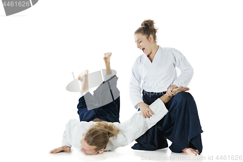 Image of Man and woman fighting at Aikido training in martial arts school