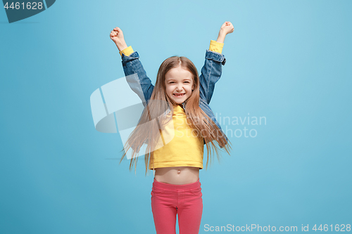 Image of Happy success teen girl celebrating being a winner. Dynamic energetic image of female model