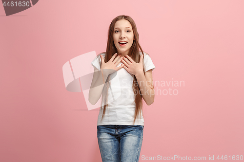 Image of Beautiful teen girl looking suprised isolated on pink