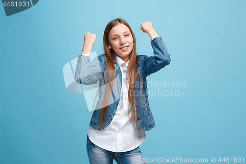 Image of Happy success teen girl celebrating being a winner. Dynamic energetic image of female model