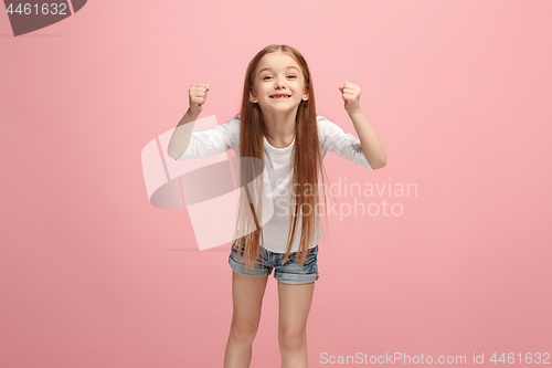 Image of Happy success teen girl celebrating being a winner. Dynamic energetic image of female model