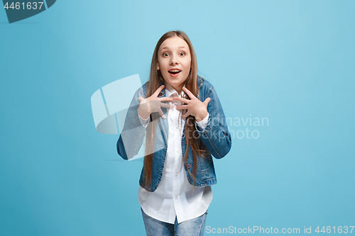 Image of Beautiful teen girl looking suprised isolated on blue