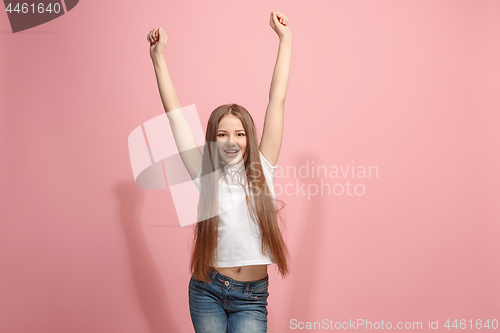 Image of Happy success teen girl celebrating being a winner. Dynamic energetic image of female model