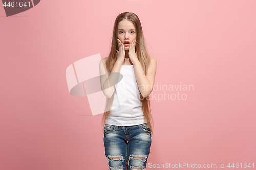 Image of Beautiful teen girl looking suprised isolated on pink