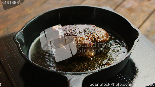 Image of Skillet with fried meat on stove