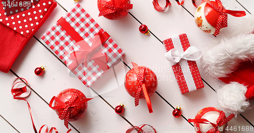 Image of Christmas hat and baubles around gifts