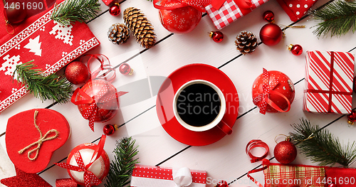 Image of Christmas decorations and presents around coffee