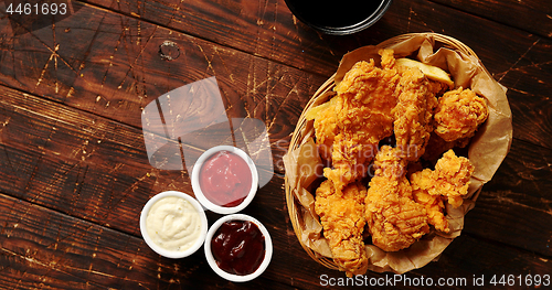 Image of Sauces and chicken wings on table